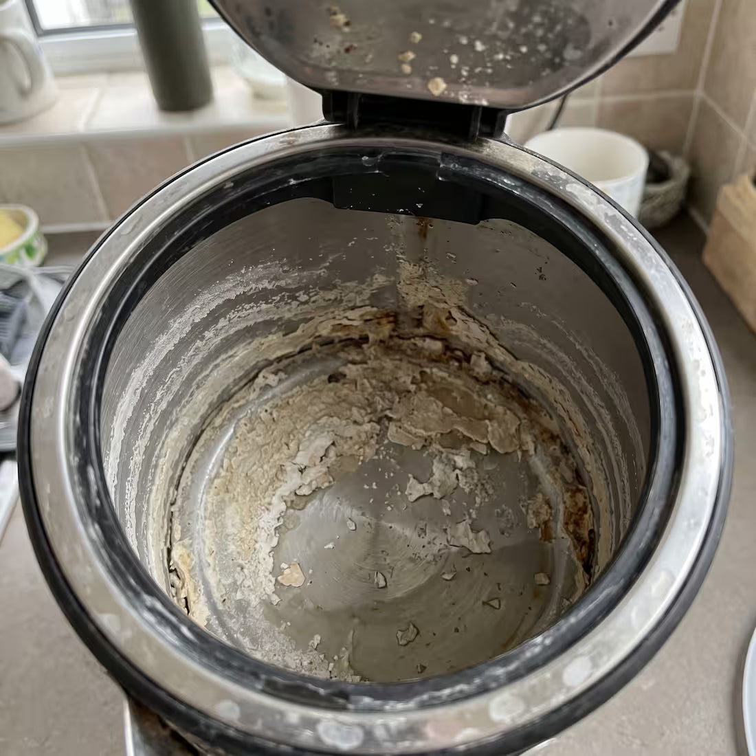 Chalky limescale built up inside an old kettle
